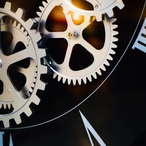 Close-up of intricate clockwork gears and roman numerals